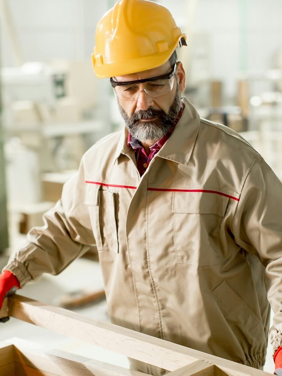 Middle aged worker working in the furniture factory